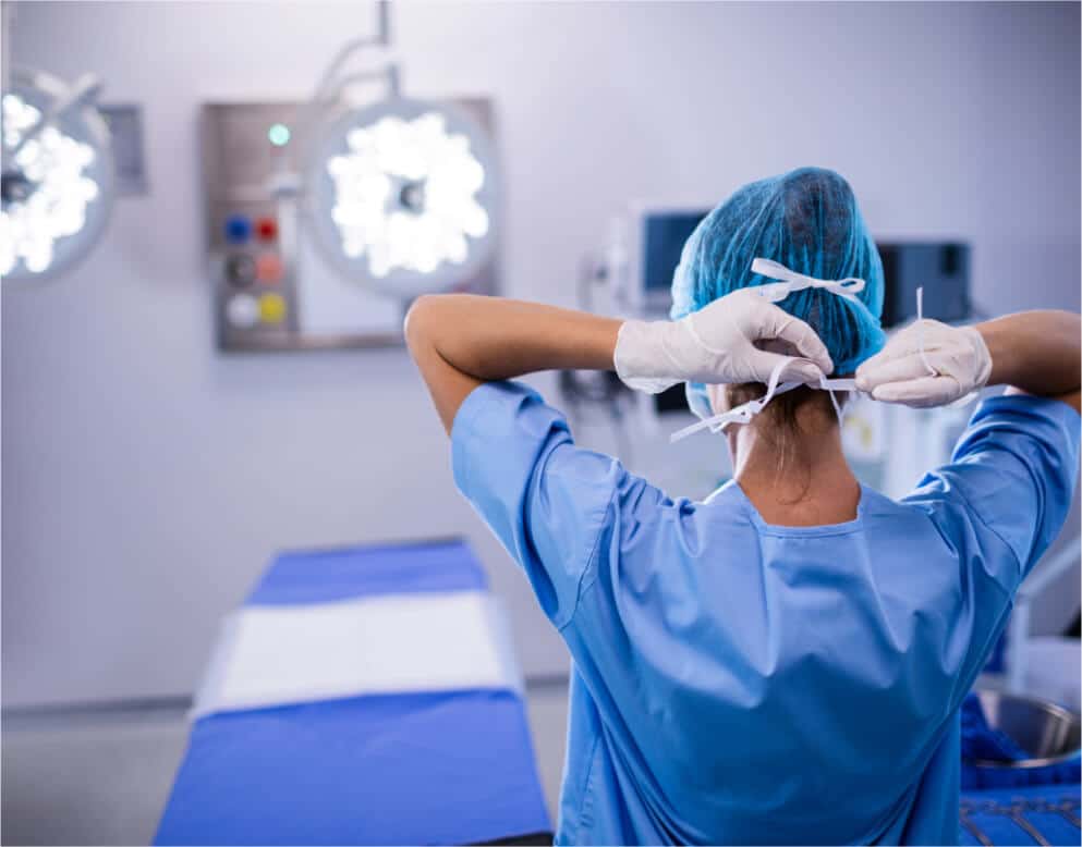 Nurse putting on mask in preparation for surgery