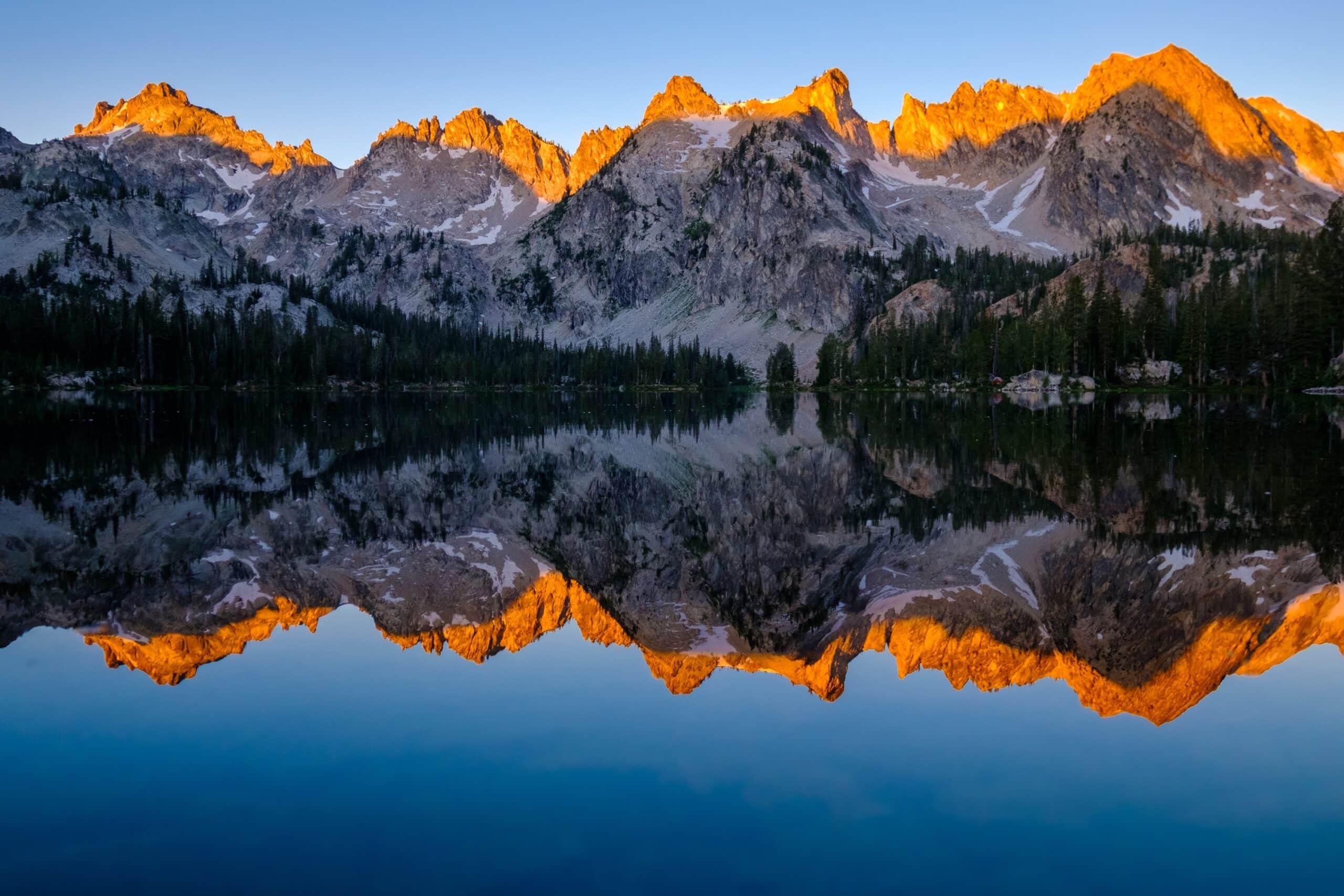 Travel Healthcare Jobs in Idaho Sunrise Illuminates Granite Peaks of The Sawtooth Range Reflected in Alice Lake, Stanley, Idaho