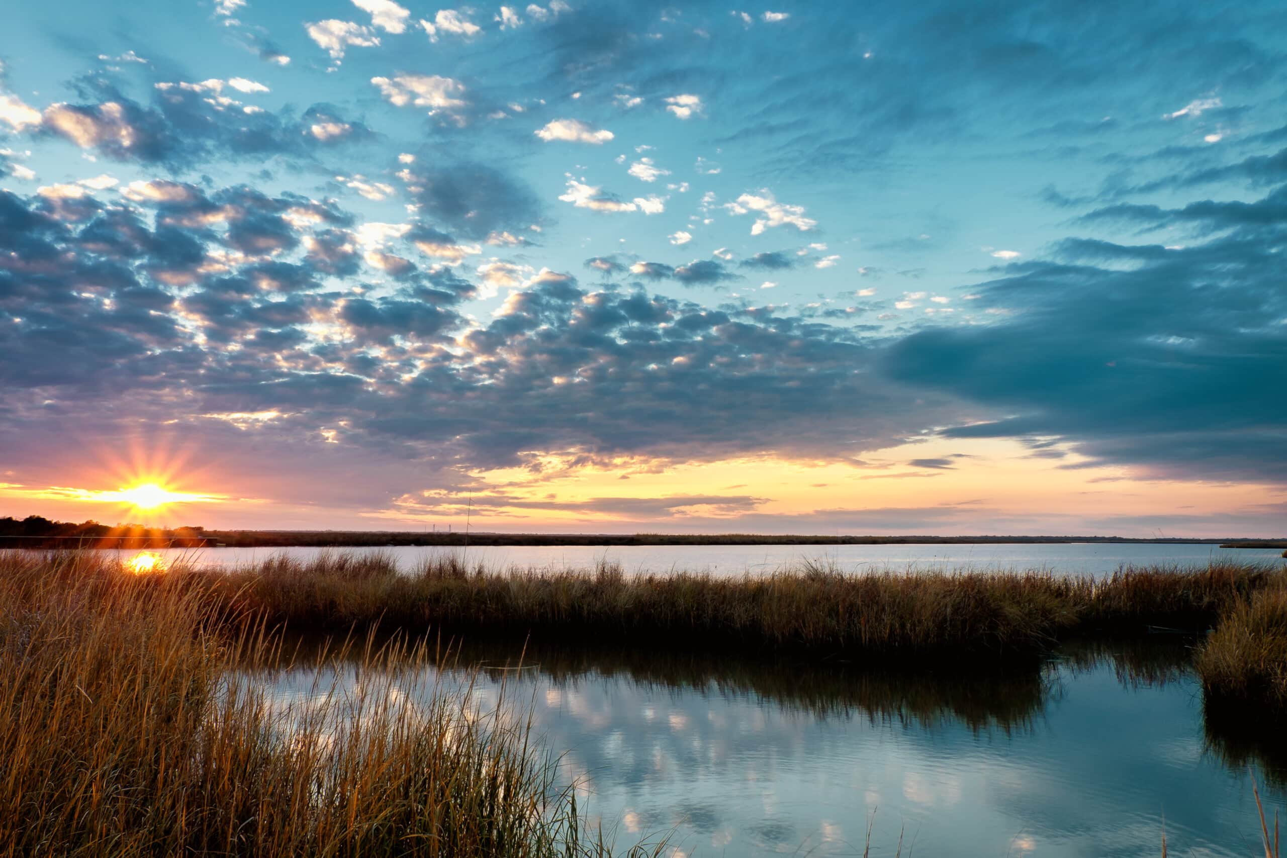 Travel Healthcare Jobs in Louisiana Setting winter sun on a Louisiana bayou