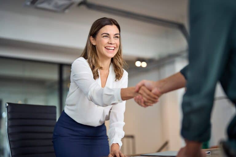 Happy middle-aged businessman shaking hands with a client after a meeting