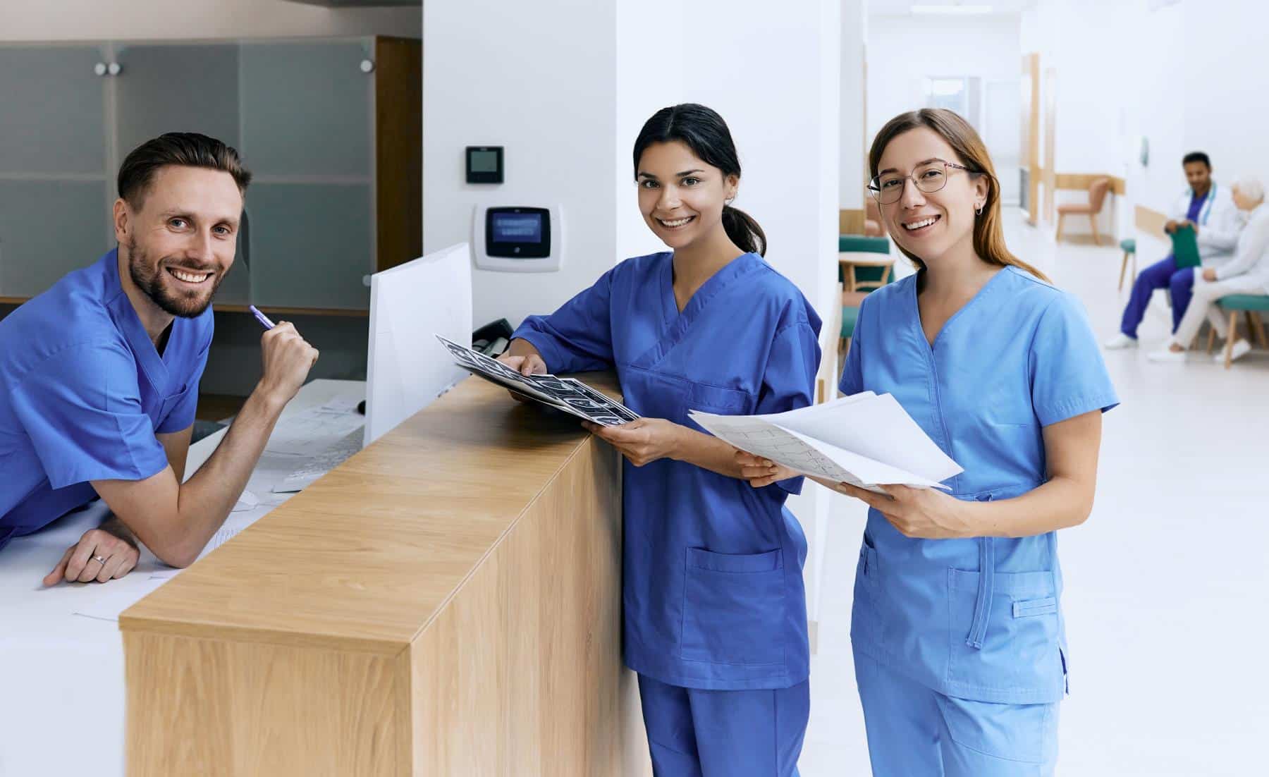 Which Allied Health Specialties Are Needed? Imaging techs holding scans, smiling at camera