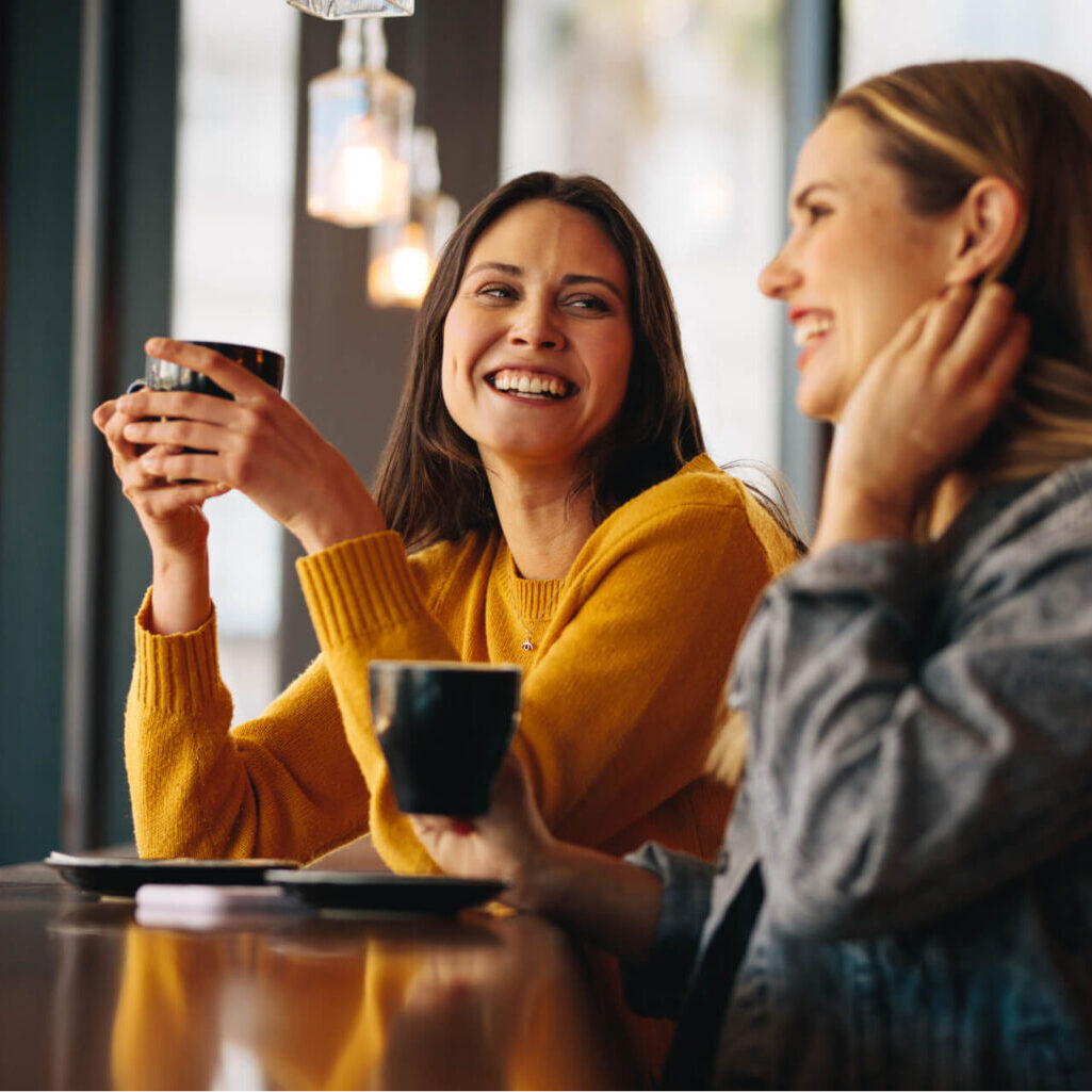 About TRS Healthcare - Our Team Two young women in cafe having coffee