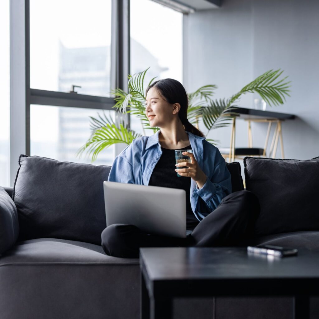 Corporate Careers: Remove Environment Young Asian woman working from home with laptop