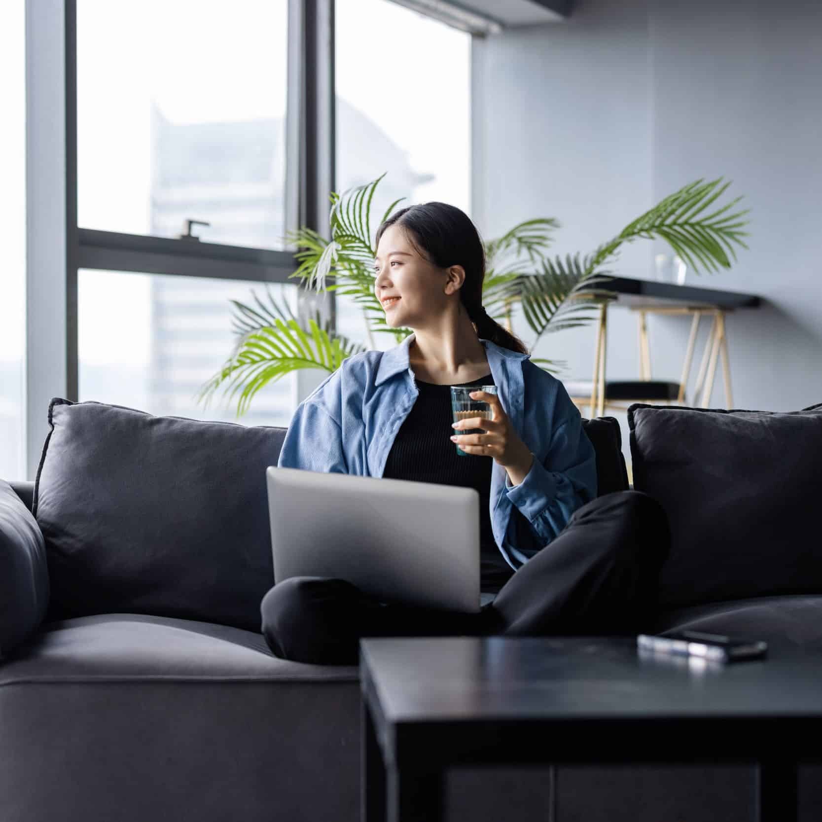 Young Asian woman working from home with laptop